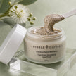 Close-up creamy texture of Bubble Clinic Triple-Action Resurfacing Facial Polish with visible botanical polishing particles