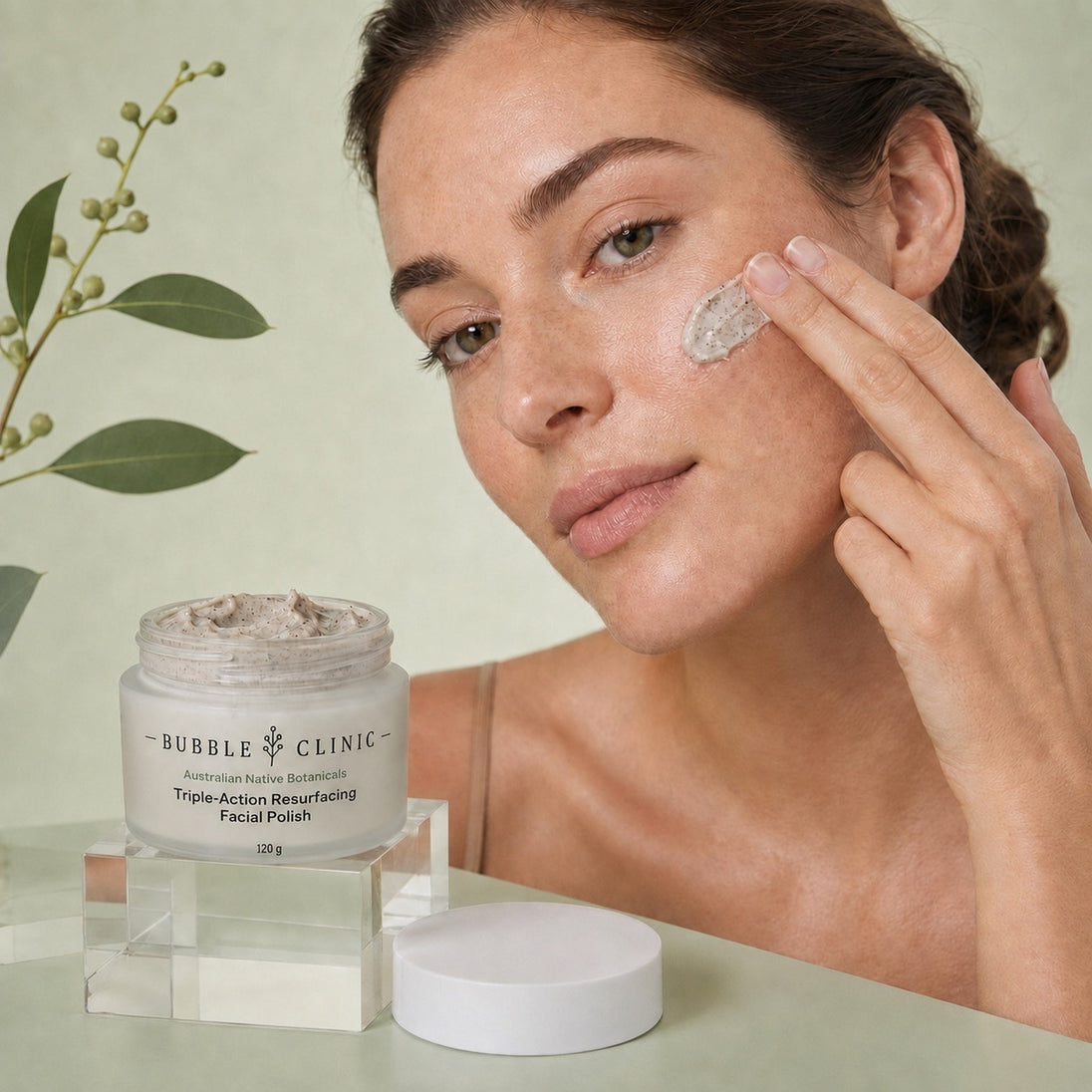 Model applying Bubble Clinic Triple-Action Resurfacing Facial Polish to cheek as part of a weekly exfoliating skincare routine