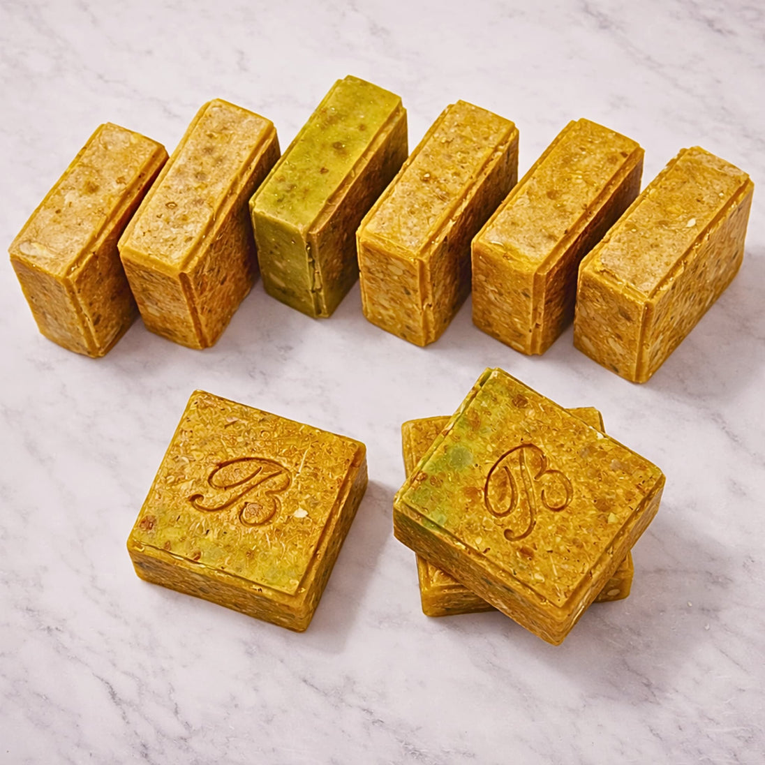 Close up of turmeric alpha arbutin soap with kojic acid, turmeric tallow and oil and scented with essential oil on a light marble surface representing best brightening organic soap Australian made.