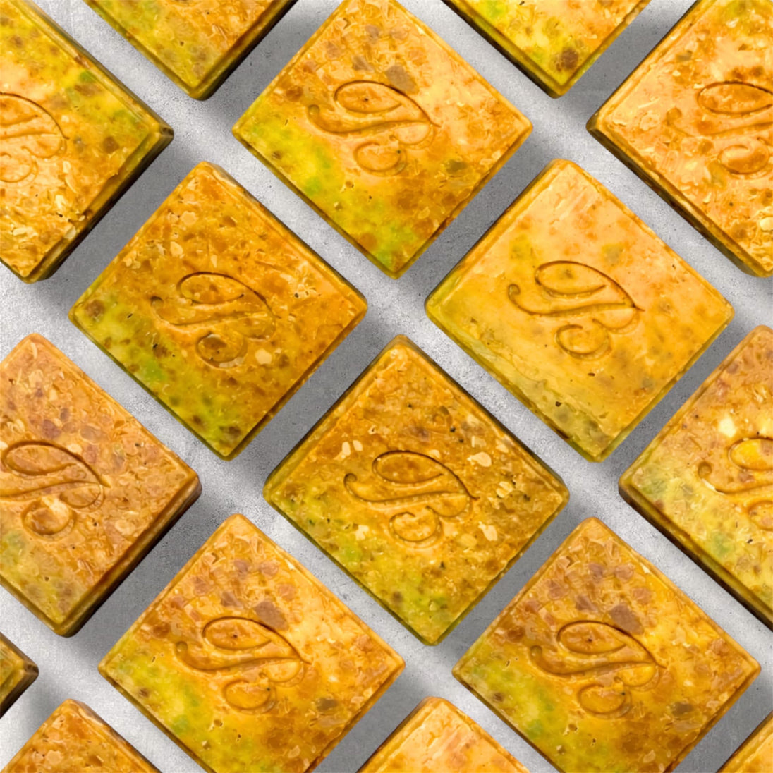 Close up of turmeric alpha arbutin soap with kojic acid, turmeric tallow and oil and scented with essential oil on a light marble surface representing best brightening organic soap Australian made.