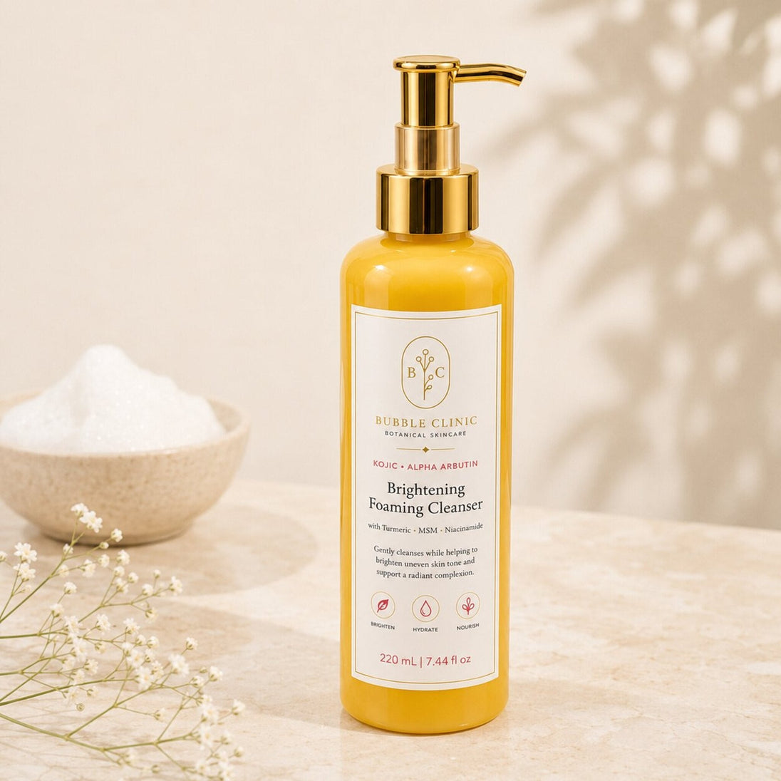 Brightening Foaming Cleanser close-up with gold pump and soft cleansing foam
