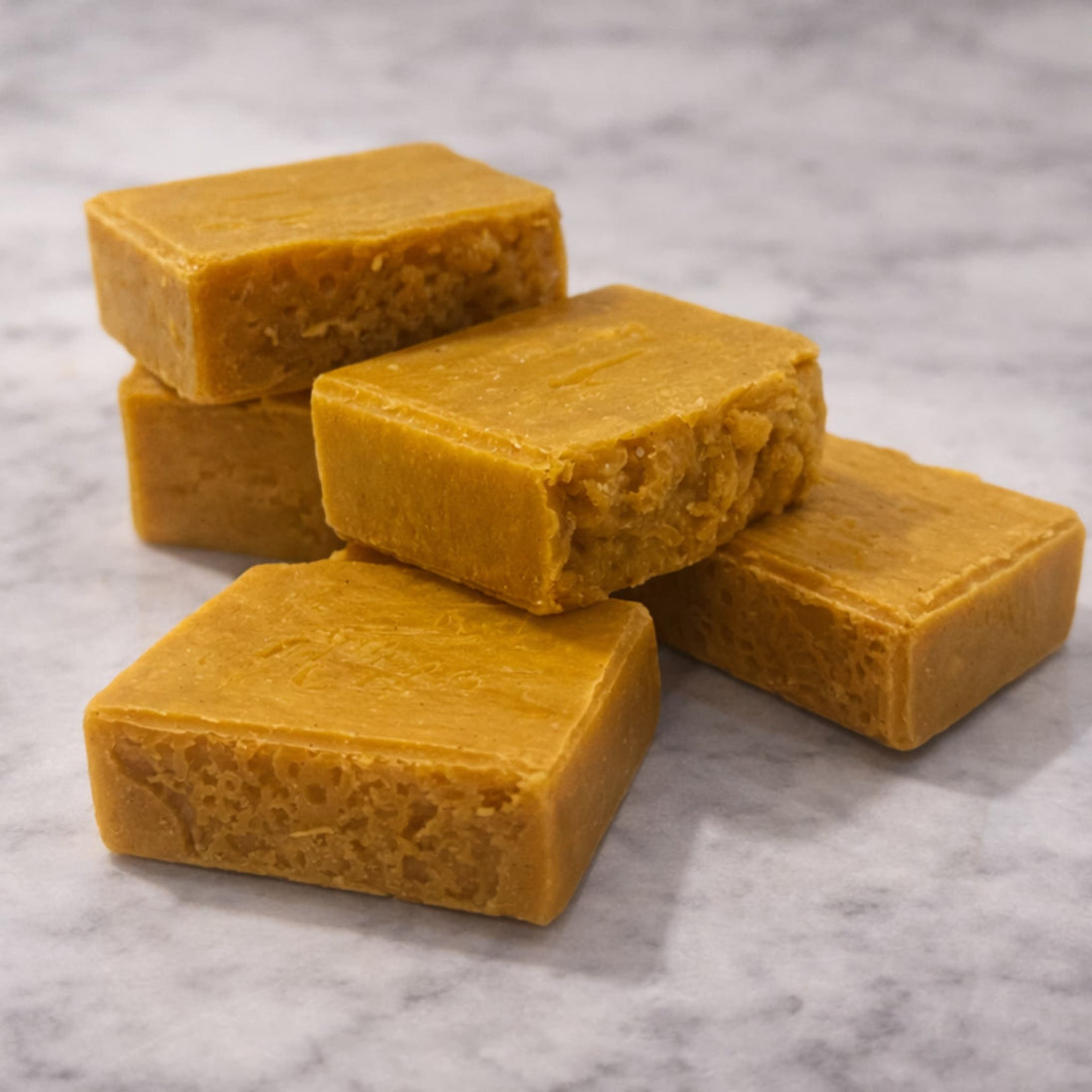 close up front and side view of 5 Turmeric natural brightening kojic acid soap on a marble surface and natural  representing natural brightening and cleansing routine Australia. 
