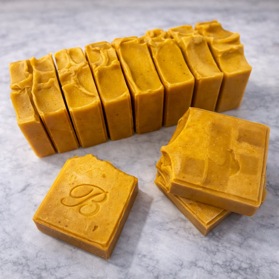 Close up of Bright Yellow natural turmeric and kojic acid soap with organic turmeric, turmeric tallow and oil and scented with essential oil on a neutral background representing best Australian brightening skincare