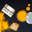 dark background with organic turmeric, ethical honey and luxury turmeric scrub jars showcasing natural organic skincare and lip care.