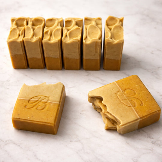 Turmeric vitamin c soap with kojic acid for natural skin glow and brighter complexion  on a light marble surface representing best brightening turmeric kojic soap with vitamin C.