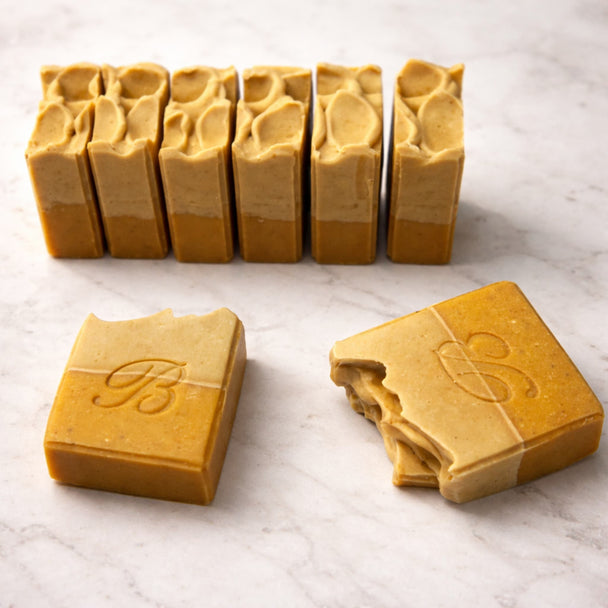 Turmeric vitamin c soap with kojic acid for natural skin glow and brighter complexion  on a light marble surface representing best brightening turmeric kojic soap with vitamin C.