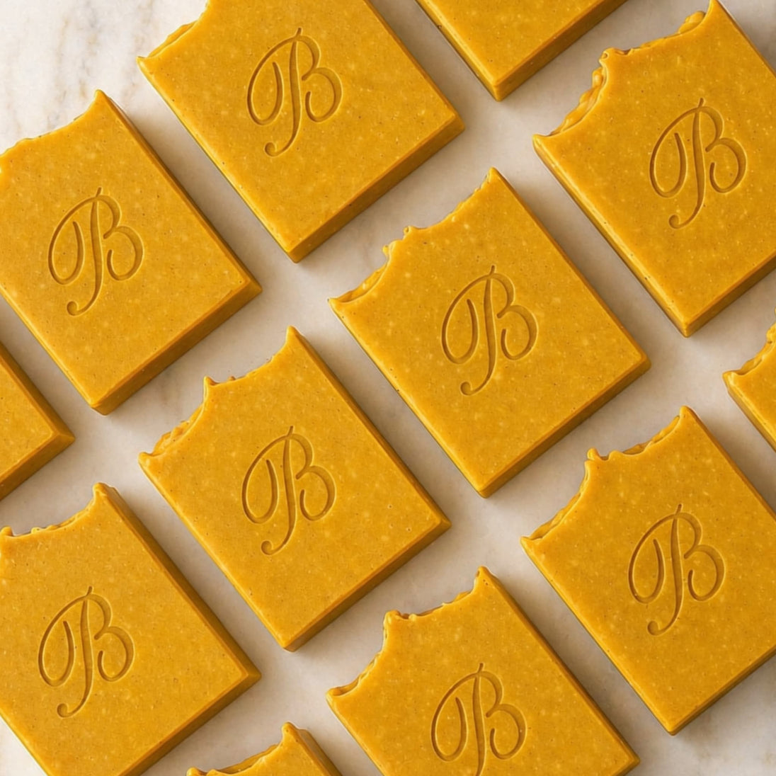 close up of flat laid Natural Brightening Turmeric Kojic Acid Soap Bars with essential oils, grass fed beef tallow, extra virgin olive oil, castor oil and coconut oil - Handmade Facial and body Cleansing Soap for Dark Spots, Acne Marks, Uneven Skin Tone and Glowing Skin Australia