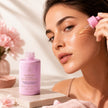 Best brightening Vitamin C and and Arbutin serum being applied by a woman to her cheek beside a pink bottle labeled LUMINOUS Vitamin C SERUM representing best Australian Skincare.