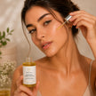 Bubble Clinic Brightening Vitamin C Face Oil with olive squalane, bisabolol and prickly pear extract being applied to glowing skin with dropper in luxury skincare lifestyle image.