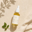 Top-down flat lay of Bubble Clinic Vitamin C Radiance Face Oil in a filled 30 mL clear bottle.