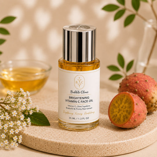 Bubble Clinic Brightening Vitamin C Face Oil applied to glowing skin with precision dropper, featuring olive squalane, bisabolol and prickly pear extract for radiant, nourished skin.