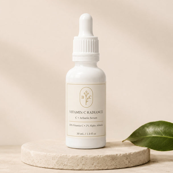 Bubble Clinic Vitamin C Radiance C + Arbutin Serum, 30 mL dropper bottle with 10% Vitamin C and 2% Alpha Arbutin on a neutral stone pedestal