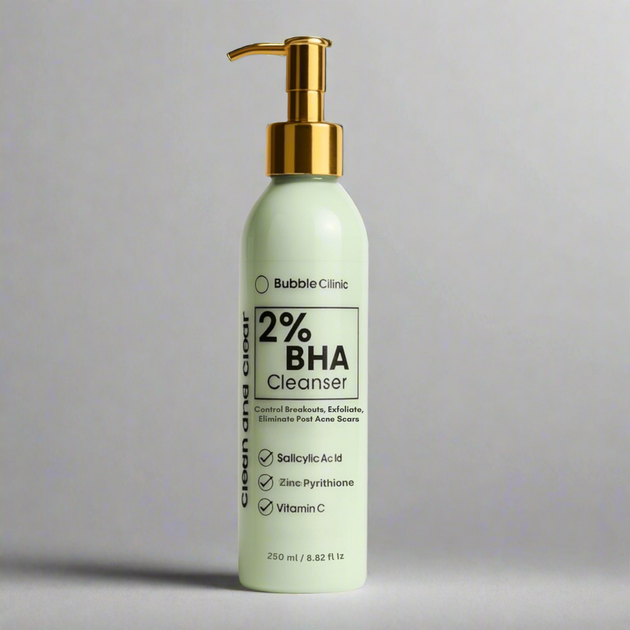 Bottle of Bubble Clinic 2% BHA Cleanser with a gold pump on a gray background representing best australian acne cleansers.