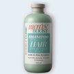 Biotin Boost shampoo bottle with a white label on a light gray background representing best australian made zinc pyrithione shampoo for flake free scalp